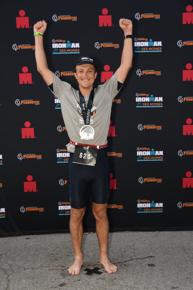 Sam Posing with his arms up after the Des Moines Iron Man