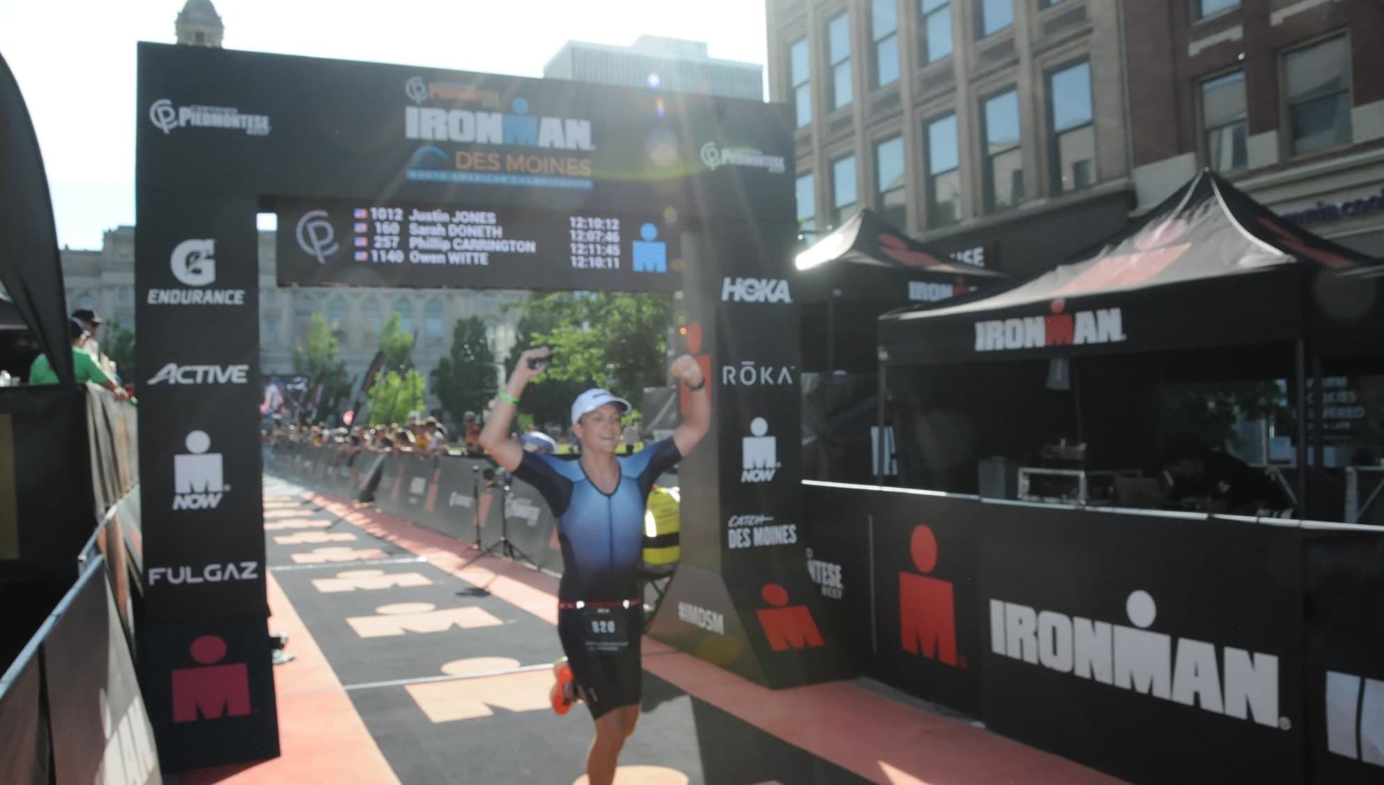 Sam Pausha crossing the finish line at the Des Moines Ironman